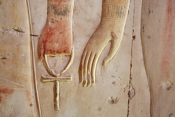 Ankh, an ancient Egyptian symbol of eternal life, in hand of a god, on the wall of the temple near Luxor (Thebes), Egypt
- 130358306