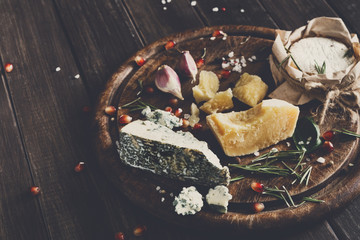Cheese delikatessen closeup on rustic wood, blue roquefort and parmesan