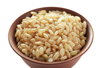 Brown short grain rice in cup closeup