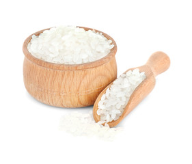 Short grain rice in wooden bowl and scoop on white background