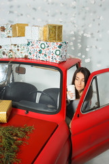 women driving a car with Christmas gifts
