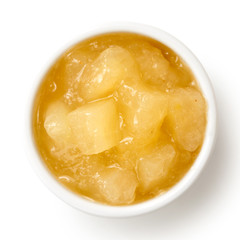 Bramley apple sauce in ceramic bowl isolated on white from above.