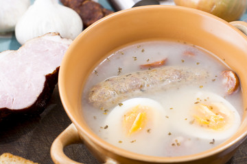 Traditional Zurek with sausage and egg, white borscht, polish Ea
