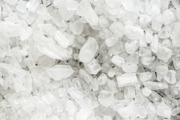 Background of coarse salt crystals from above.