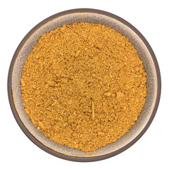 Organic ras el hanout royal spice in ceramic bowl isolated on white background, top view