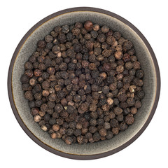 Organic tellicherry black pepper in ceramic bowl isolated on white background, top view