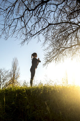 A Latina teenager practicing yoga in an urban park in Barcelona