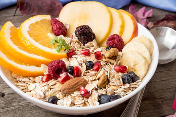 Healthy breakfast. Muesli with orange fruit, apple, pomegranate,