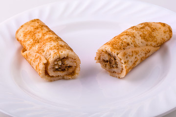 sliced pancakes with liver on a plate