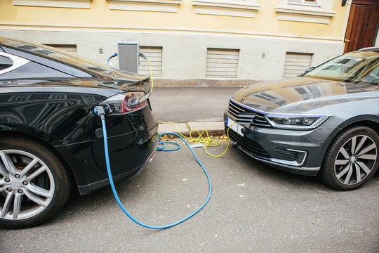 Electric car charging. City street.