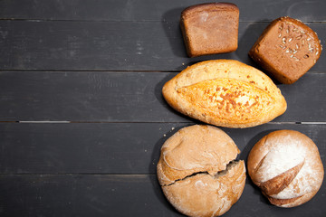 Homemade bread on a black wooden background