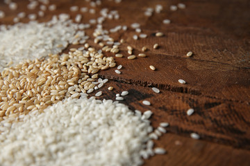Different kinds of rice on wooden table