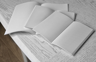 Blank open brochures on wooden table