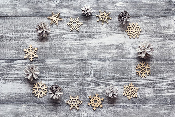 Background with a frame of decorative wooden snowflakes and whit