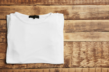 Blank white t-shirt on wooden background