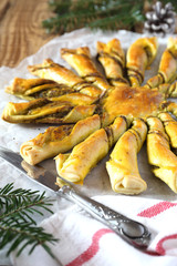 Tarte soleil. New Year  pastry: pesto sun pie and fir branch