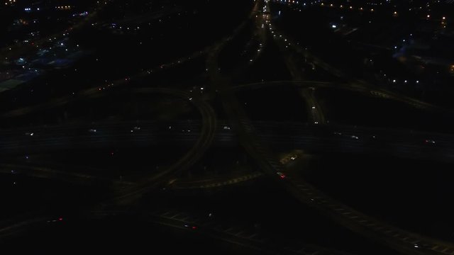 Tilting aerial shot of Spaghetti Junction, the M6, A38M and Birmingham city centre, UK.