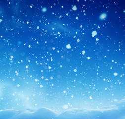 Christmas winter background with snow and blurred bokeh.