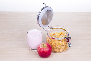 breakfast with cereal, milk and apple

