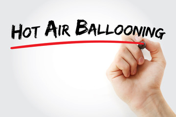 Hand writing Hot air ballooning with marker, concept background