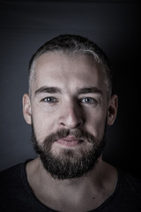 Obraz premium Portrait of a young man with a beard. Toned