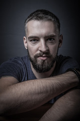 Obraz premium Portrait of a young man with a beard. Toned