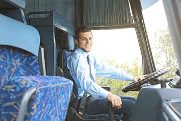 Handsome driver sitting in bus