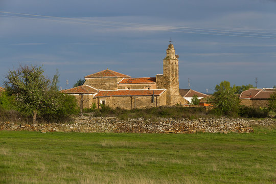 Pradera y campos con cercado de piedras e iglesia en Luyego, Leon, Espa&ntilde;a