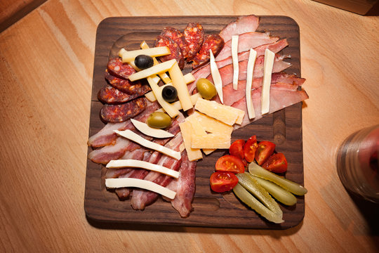 Meat appetizer on wooden board