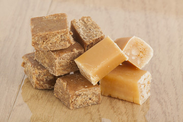 tasty caramel toffee on brown background
