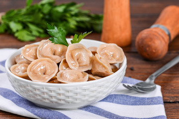 Boiled prepared homemade russian dumplings or pelmeni with beef meat