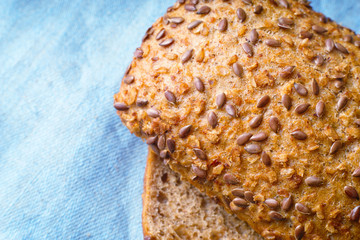 Wholegrain bread on the blue cloth top view