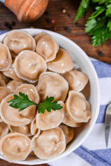 Boiled prepared homemade russian dumplings or pelmeni with beef meat