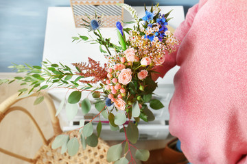 Closeup of female hands holding beautiful bouquet of flowers