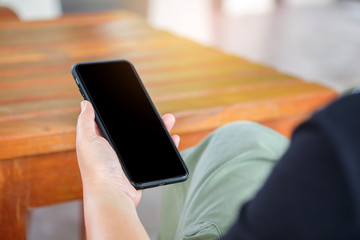 Hand holding a smartphone with white.