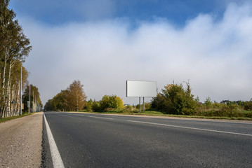 Blank billboard on highway and the background of sky with clouds
