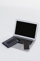 Laptop, digital tablet and mobile phones on white background