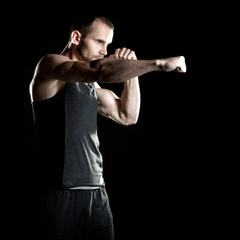 muscular man, hour boxer, black background, shot to the right