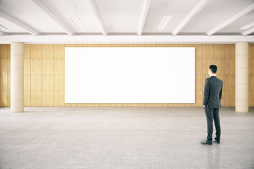 Man looking at empty poster