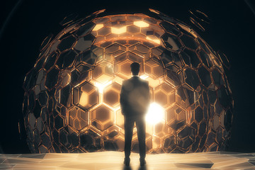 Man in front of golden sphere