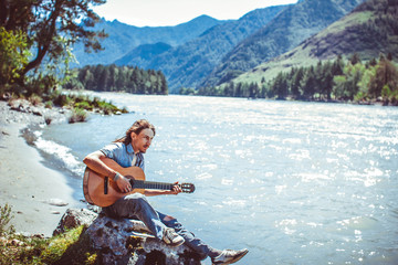 the guy with the guitar by the river