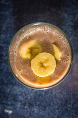 Fresh banana smoothie in a glass. Top view