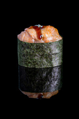 Gunkan maki sushi with salmon isolated on black background