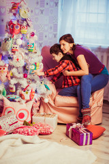 Fototapeta premium mother and son decorating Christmas tree