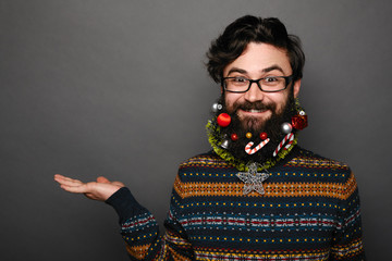 man in sweater pointing to copy space.