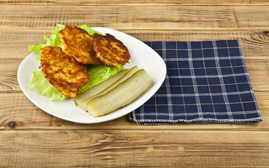 potato pancakes and pickles in a bowl