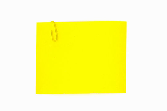 A Yellow Post It Paper With A Paper Clip Isolated On White Background