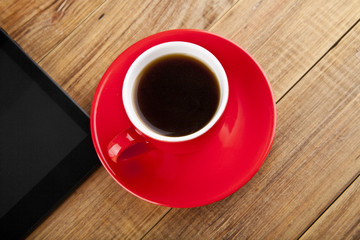 black tablet PC and coffee Cup