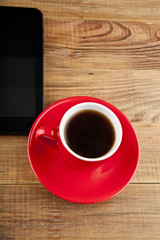 black tablet PC and coffee Cup