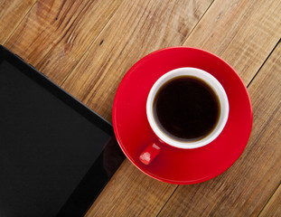 black tablet PC and coffee Cup